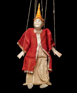 puppet on strings with conical hat and read and gold trimmed robe