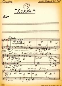 A handwritten musical score with annotations in red pencil.